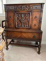 Full front view of dresser showing overall design, drawer layout, turned legs.