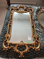 Full front view of mirror showing overall carved frame design and condition