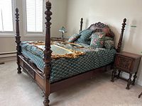 Full view of four poster bed with mattress, bedding and pillows