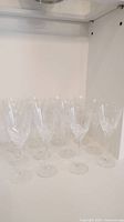 Group of 12 DaVinci crystal wine glasses arranged together showing their clear glass and cut design.