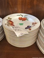 Stack of Evesham fruit motif porcelain bowls with gold rim