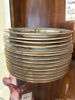 Stack of about 14 ceramic bread plates