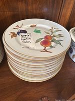 Stack of approximately 15 Royal Worcester Evesham dinner plates showing fruit motif and gold rim