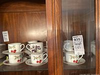 Display of Royal Worcester Evesham tea cups stacked with matching saucers, showing cherry and blackberry fruit designs.