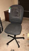 Full view of black office chair with mesh backrest and cushioned seat showing overall condition and design.