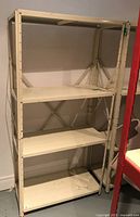 Shelving unit shown fully assembled from front/right angle in indoor basement setting with neutral walls and concrete floor.