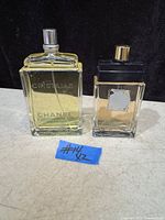 Two Chanel Cristalle bottles side by side on neutral surface