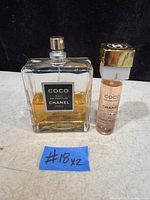 Photo showing two Coco Chanel Eau de Parfum bottles on a surface with a marked tag #18x2.