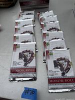 Multiple sealed packs of 2001-2002 Upper Deck Honor Roll hockey cards laid out in rows on table.