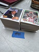 Two stacks of vintage NBA basketball cards with visible top cards showing Kevin Johnson and Bernard King in good condition.
