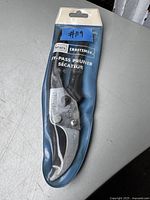Sears Craftsman bypass pruner in original sealed retail packaging on grey surface.