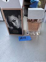 Photo of Rogue Love Eau de Parfum bottle and original box featuring a black-and-white image of Rihanna on the box.