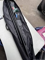 Hammock stand components and bag lying open on a table showing metal parts and assembly hardware.