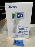 Photo of Berrcom branded box showing front view of non-contact infrared thermometer model JXB-178 with product details in English and French.