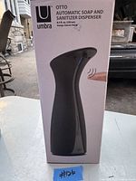 Photo of the Umbra Otto automatic soap and sanitizer dispenser box showing product image, brand, capacity and designer.