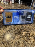Front view of the unopened ZIRH IKON men's eau de toilette four-piece gift set in clear blue plastic packaging on a kitchen counter.