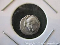 Front side of silver Diobol coin showing the Corinthian helmet design.