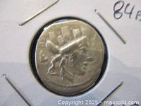 Front side of ancient silver denarius showing helmeted bust in profile.