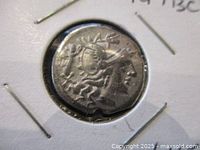 Close-up of obverse side of ancient silver denarius showing bust of Caius Terentius Lucanus.