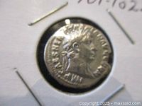 Obverse of silver denarius showing laureate head of Emperor Trajan right with inscription.