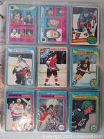 First vinyl sheet with nine hockey cards showing players from New York Rangers, Philadelphia Flyers, Boston Bruins, Washington Capitals, and Hartford Whalers.