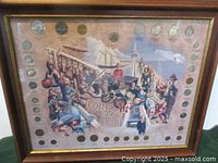 Framed wood and glass display with 35 Canadian coins set around an illustrated background showing Canadian historical scenes and personalities, titled 'Coins of the 20th Century'.