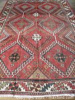 Full view of the Persian Lori wool area rug showing geometric diamond panel design and floral border