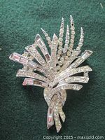 Close-up photo of the Marcel Boucher vintage rhinestone brooch showing cascading strands of clear rhinestones and baguette-cut stones.