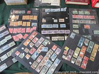 Six black binder pages arranged on a table