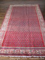 Full view of vintage hand knotted Persian MIR rug laid flat on wood floor, showing pattern and colors.