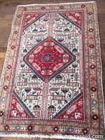 Full view of vintage Persian Tabriz wool rug showing geometric, floral, and medallion patterns in vibrant colors.