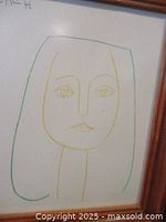 Framed lithograph close-up showing minimalist line drawing of a woman's face in green and yellow lines.