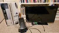 Photo showing Samsung 26 inch TV, remote, Blu-ray player, and Naxa antenna with circular ring
