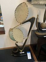 Front view of lamp showing triangular frame and two scalloped disc shades