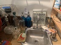 Overview of sink area with assorted barware