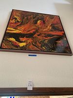 Full view of framed abstract painting mounted on wall