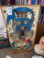 Full view of the Jokerz! 567 pinball machine top cover piece showing clown artwork and pinball elements.