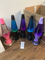All five lava lamps lined up on tabletop