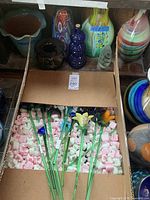 Box of long‐stem glass flowers packed in foam peanuts
