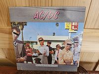 Front cover of AC/DC Dirty Deeds Done Dirt Cheap LP album, showing band members and album title with visible wear.