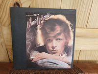 Front cover of David Bowie Young Americans LP showing textured finish and Bowie's portrait with cigarette.