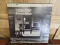 Front cover of Elton John Tumbleweed Connection vinyl showing storefront in black and white