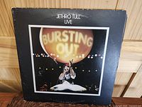Front cover of Jethro Tull live double LP album showing embossed gatefold cover and 'BURSTING OUT' light photo.