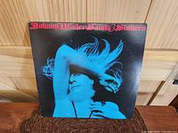Front cover of Johnny Winter Saints & Sinners LP showing blue-tinted image of the artist
