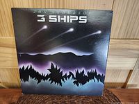 Front cover of Jon Anderson 3 Ships album, showing night sky and comet-like ships artwork.