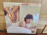 Front cover of Mick Jagger 'She's The Boss' LP album showing Mick Jagger on a bed.