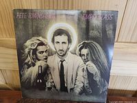 Front cover of Pete Townshend's 'Empty Glass' LP showing the artist with two women and a halo effect