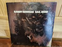 Front cover of the Randy Newman Sail Away LP showing artistic portrait with title text.