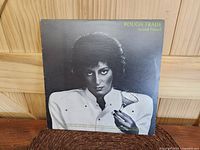 Front cover of Rough Trade Avoid Freud LP showing black and white woman holding martini glass against dark background with yellow 'Rough Trade Avoid Freud' text.