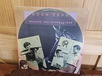Front cover of Rough Trade 'Shaking The Foundations' LP showing collage artwork and title